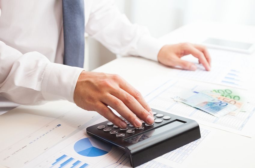 Businessman checking numbers on a document